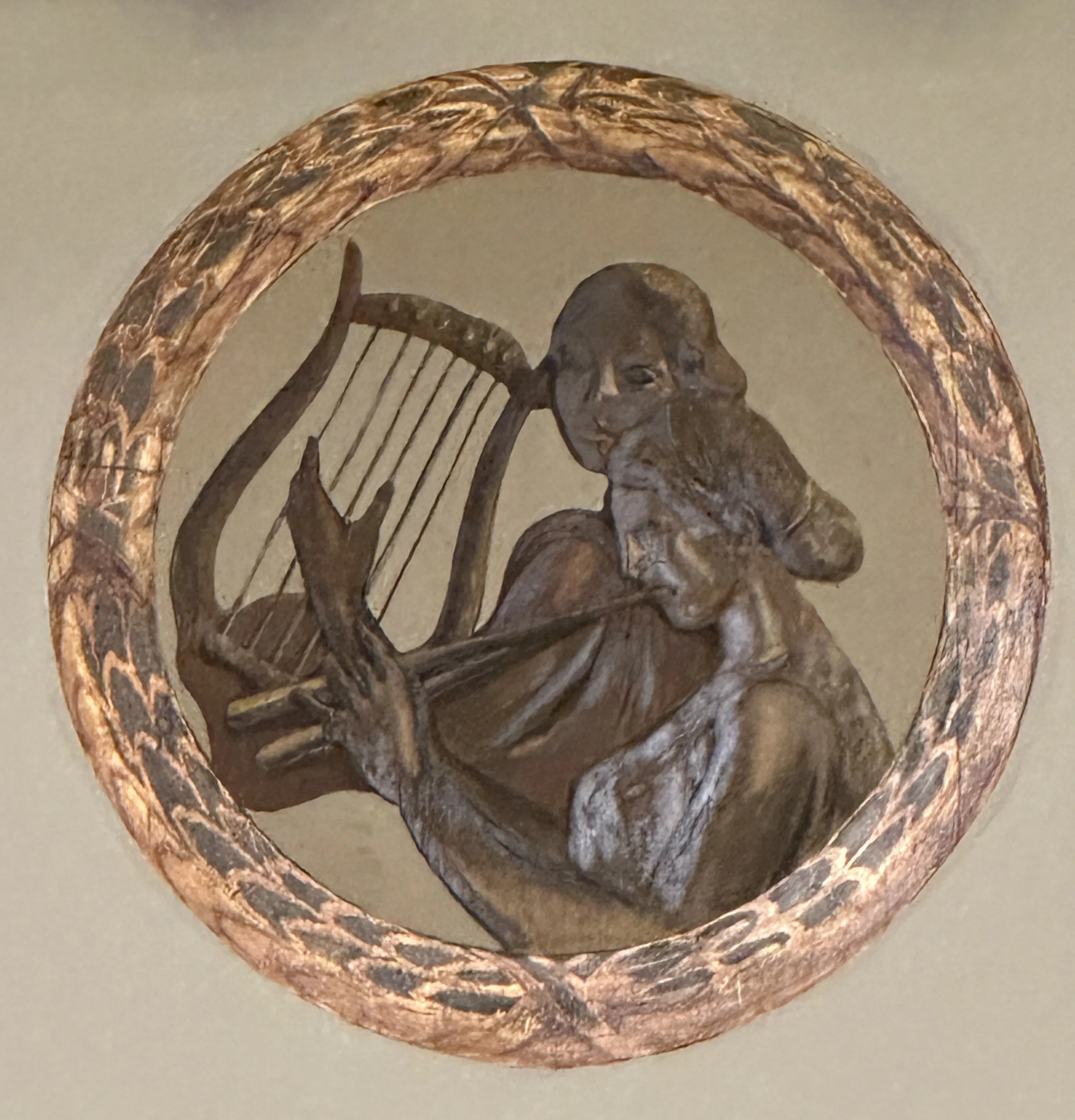 Fotografía detalle del medallón que se encuentra sobre el escenario del teatro Filarmónica, en el que aparecen dos musas y un arpa
